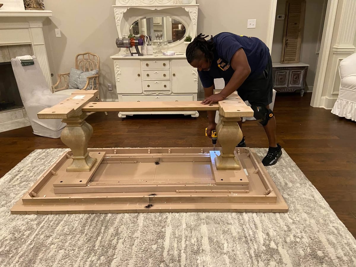 Reuben assembling a large pedestal dining room table